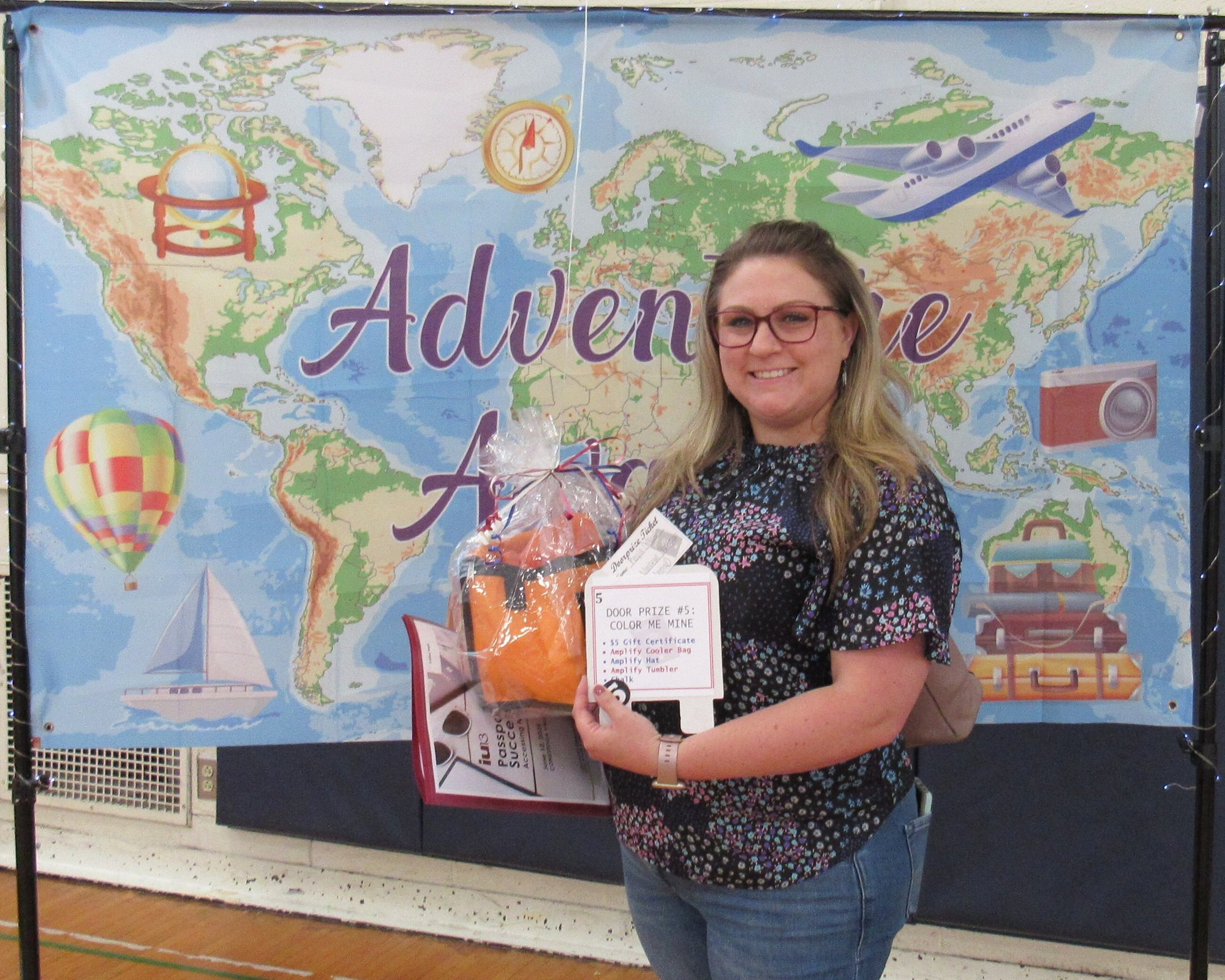 Smiling woman holding gift package in front of banner showing a map of the world. Smiling woman holding gift package in front of banner showing a map of the world.
