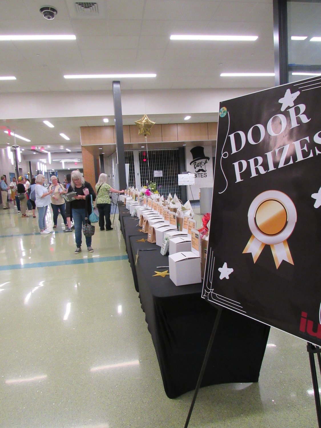 Door Prizes sign next to table with small boxes Door Prizes sign next to table with small boxes